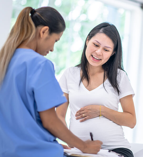 obstetrician talking to pregnant patient