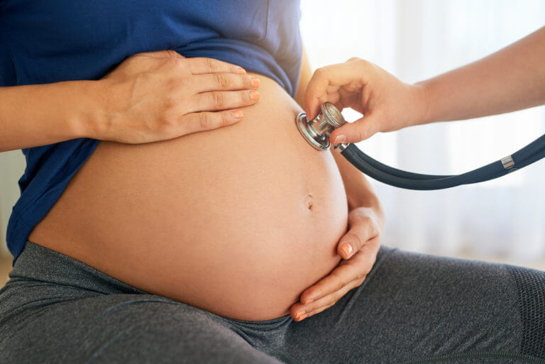 Pregnant woman who is being checked by a Prenatal Care Doctor.