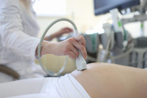 Gynaecologists doing ultrasound examination of pregnant woman