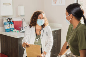 young lady consulting with doctor at women's health center